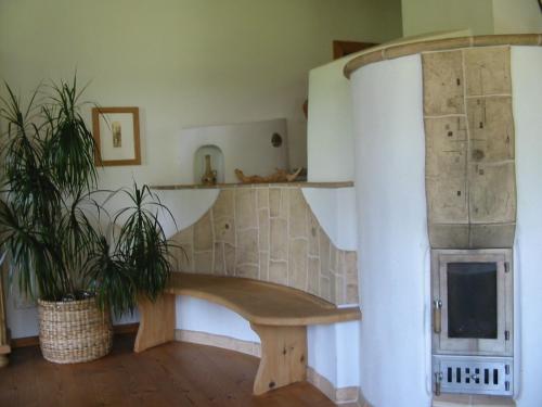 a living room with a wooden bench next to a fireplace at Ferienwohnung Am Pflanzgarten in Ebensee