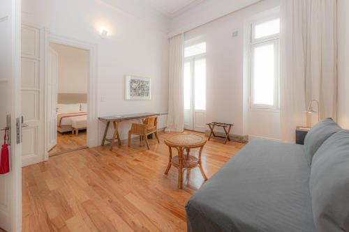 a living room with a couch and a table at Cassa Lepage Art Hotel Buenos Aires in Buenos Aires