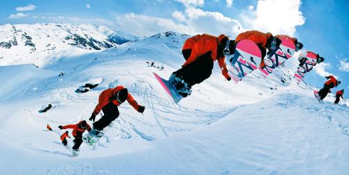 a man riding a snowboard down a snow covered mountain at Hanserhof in Zell am Ziller