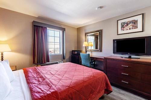 a hotel room with a bed and a flat screen tv at Americas Best Value Inn - Temple in Temple
