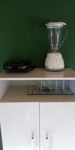 a blender sitting on top of a shelf at Pousada Pontal do Moleque in Carrancas