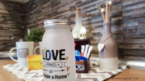 a mason jar with love written on it on a table at Studio Central Exer I in Bucharest