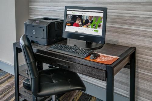 a desk with a computer and a printer on it at Holiday Inn Rocky Mount I-95 @ US 64 by IHG in Rocky Mount