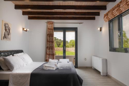 מיטה או מיטות בחדר ב-Villa Athos