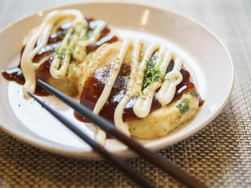 a plate of food with noodles on a table at Super Hotel Midosujisen Esaka in Suita