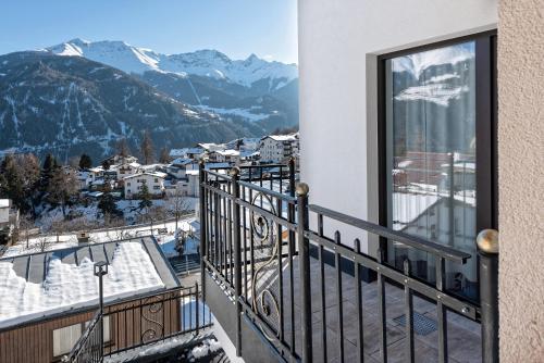 a balcony with a view of snow covered mountains at Apart Alpengenuss in Ladis