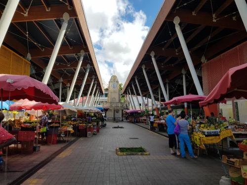 a market with a clock tower in the background at Chez Ena la fibre internet et le calme in Saint-Claude