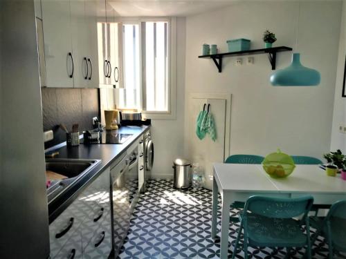 a kitchen with a sink and a table with chairs at CASA LUCA in Estepona