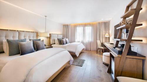 a bedroom with a large bed and a living room at Cartesiano Boutique & Wellness Hotel in Puebla