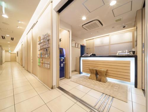 a hallway with a bar in a building at Super Hotel Midosujisen Esaka in Suita