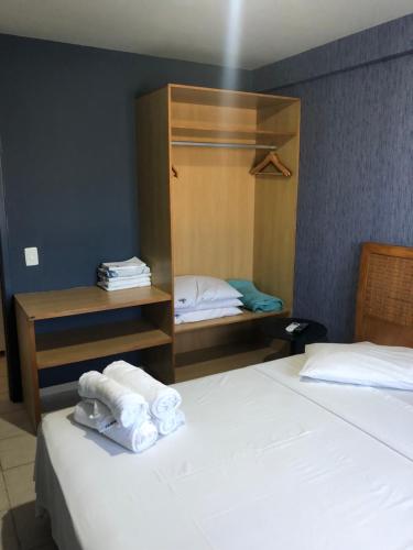 a hotel room with two beds with folded towels at Muro Alto Suites - Marupiara in Porto De Galinhas