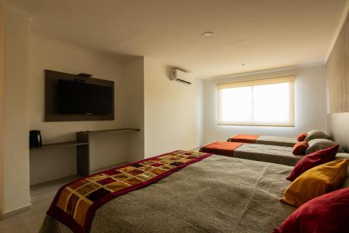 Ένα ή περισσότερα κρεβάτια σε δωμάτιο στο Hotel Las Piedras