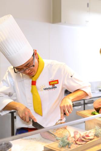 a chef is preparing food in a kitchen at LEGOLAND Japan Hotel in Nagoya