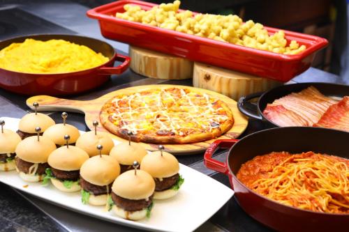 a table topped with pizzas and other dishes of food at LEGOLAND Japan Hotel in Nagoya