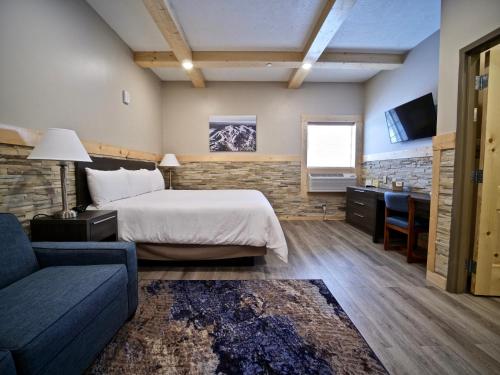 a hotel room with a bed and a couch at Caberfae Peaks Ski & Golf Resort in Harrietta