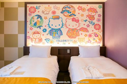 two beds in a room with a painting on the wall at HOTEL OKINAWA WITH SANRIO CHARACTERS in Naha