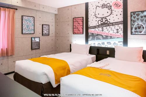 two beds in a room with at HOTEL OKINAWA WITH SANRIO CHARACTERS in Naha