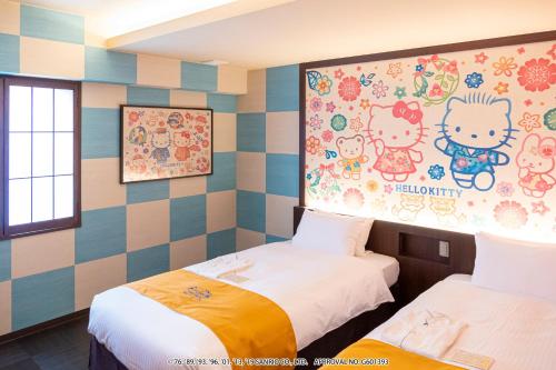 a room with two beds and a painting on the wall at HOTEL OKINAWA WITH SANRIO CHARACTERS in Naha