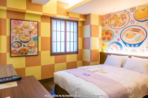 a bedroom with a large bed and colorful walls at HOTEL OKINAWA WITH SANRIO CHARACTERS in Naha