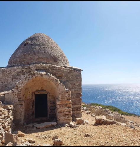 an old building on top of a mountain at TO VOTSALO-beach side studios & taverna in Karpathos Town