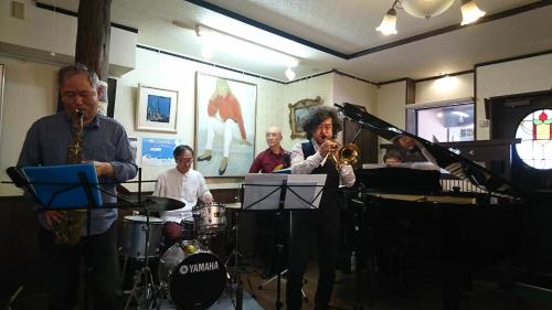 a group of musicians playing instruments in a room at Live Cafe Hisui no Umi in Itoigawa