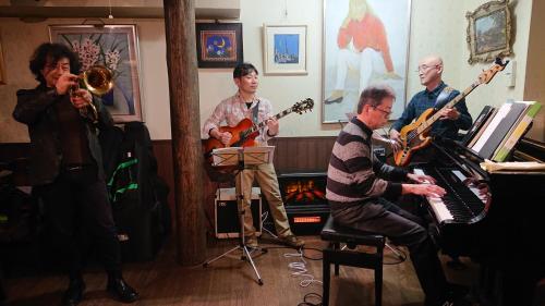 a group of people playing instruments in a room at Live Cafe Hisui no Umi in Itoigawa