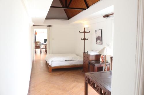 a bedroom with a bed and a cross on the wall at Davidduc 224 Âu Cơ in Hanoi