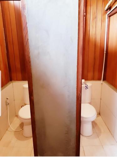 a bathroom with a toilet and two toilets sidx sidx sidx at Korpak Villa & Resort Raja Ampat in Saonek