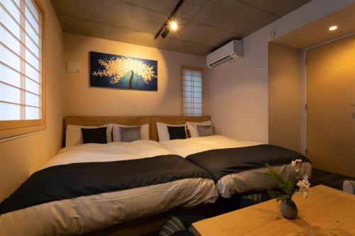 Giường trong phòng chung tại Sakura Stay Otorii