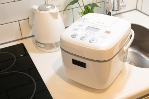 a mixer sitting on a counter next to a sink at Sakura Stay Otorii in Tokyo