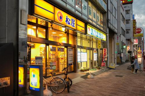 a building with a bike parked in front of it at Sakura Stay Otorii in Tokyo