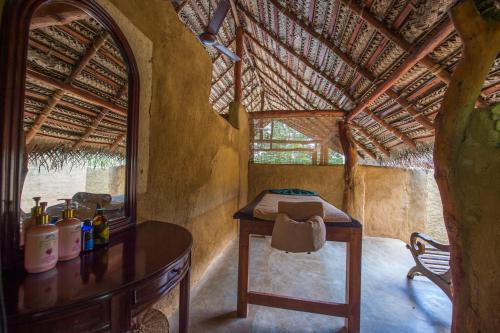 
a small room with a bed and a window at Kalu's Hideaway Udawalawe in Udawalawe
