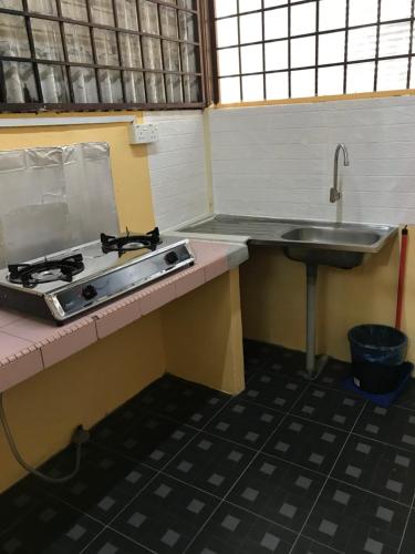 a kitchen with a stove and a sink at PJM HILL VIEW HOMESTAY in Ipoh