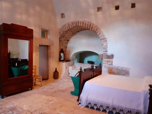 a bedroom with two beds and an archway at Posta Santa Croce in Bisceglie