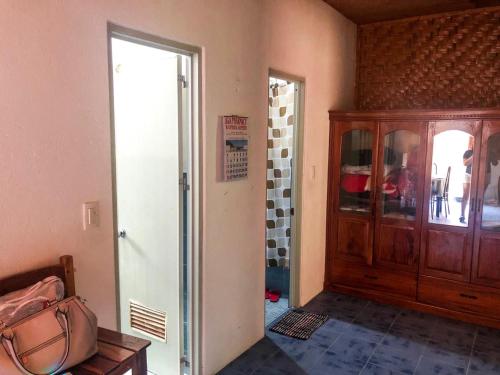 a room with a door to a room with a cabinet at SHUKRAN Apartelle in Siquijor