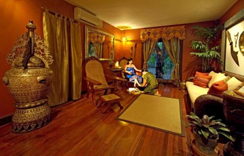 a young boy sitting in a living room at Costabella Tropical Beach Hotel in Mactan