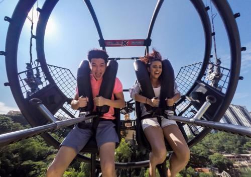 two people riding on a roller coaster at an amusement park at Sunway Pyramid Hotel in Kuala Lumpur