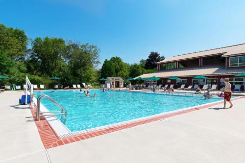 a large swimming pool with people in it at Hershey Camping Resort Loft Park Model 7 in Mount Wilson