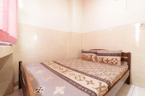 Postel nebo postele na pokoji v ubytování Hotel Omah Ampel Syariah