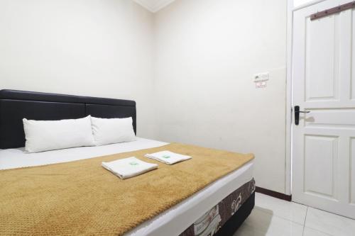 Postel nebo postele na pokoji v ubytování Hotel Omah Ampel Syariah