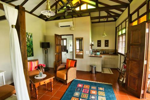 a living room with a couch and a table at Villa Kelapa Langkawi in Kuah
