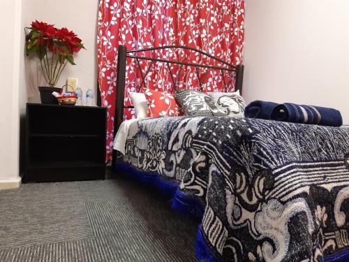 a bedroom with a bed with a patterned blanket at Alameda House in Mexico City
