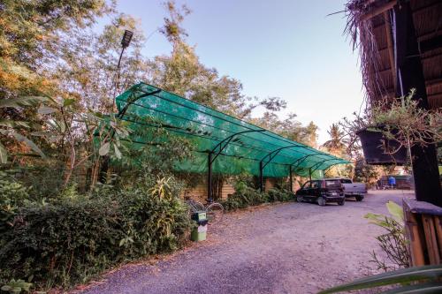 a green cover over a parking lot with a truck at The Sanctuary Villa Battambang in Battambang
