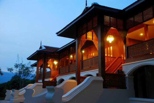 a building with lights on it at night at Khum Khun Wang Resort in Mae Wang