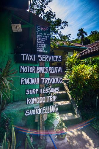 a sign that says taxi services andotorentsricalricalyrinthyrinthyrinthyrinthyrinth at ADELYA HOMESTAY in Praya