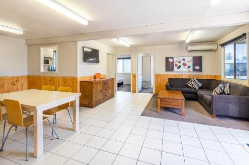 a living room with a table and a couch at Ingenia Holidays Nepean River in Emu Plains