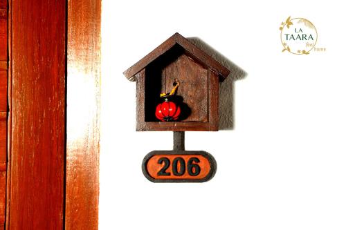 a bird house with an apple in it at La Taara - Feel Home in Auroville