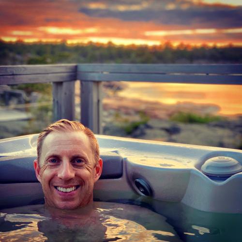 a man in a jacuzzi bathtub with at Klipphus 3 Guerilla Hotel - Geta, Åland in Geta