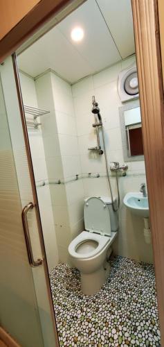 a bathroom with a toilet and a sink at Cebu Hostel in Hong Kong