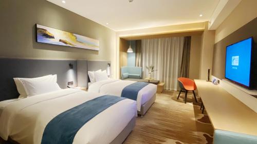 Ένα ή περισσότερα κρεβάτια σε δωμάτιο στο Holiday Inn Express Liaocheng Chiping by IHG